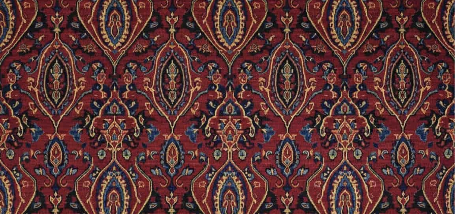 Image de motif ethnique perse sur un tapis rouge, bleu, jaune et noir